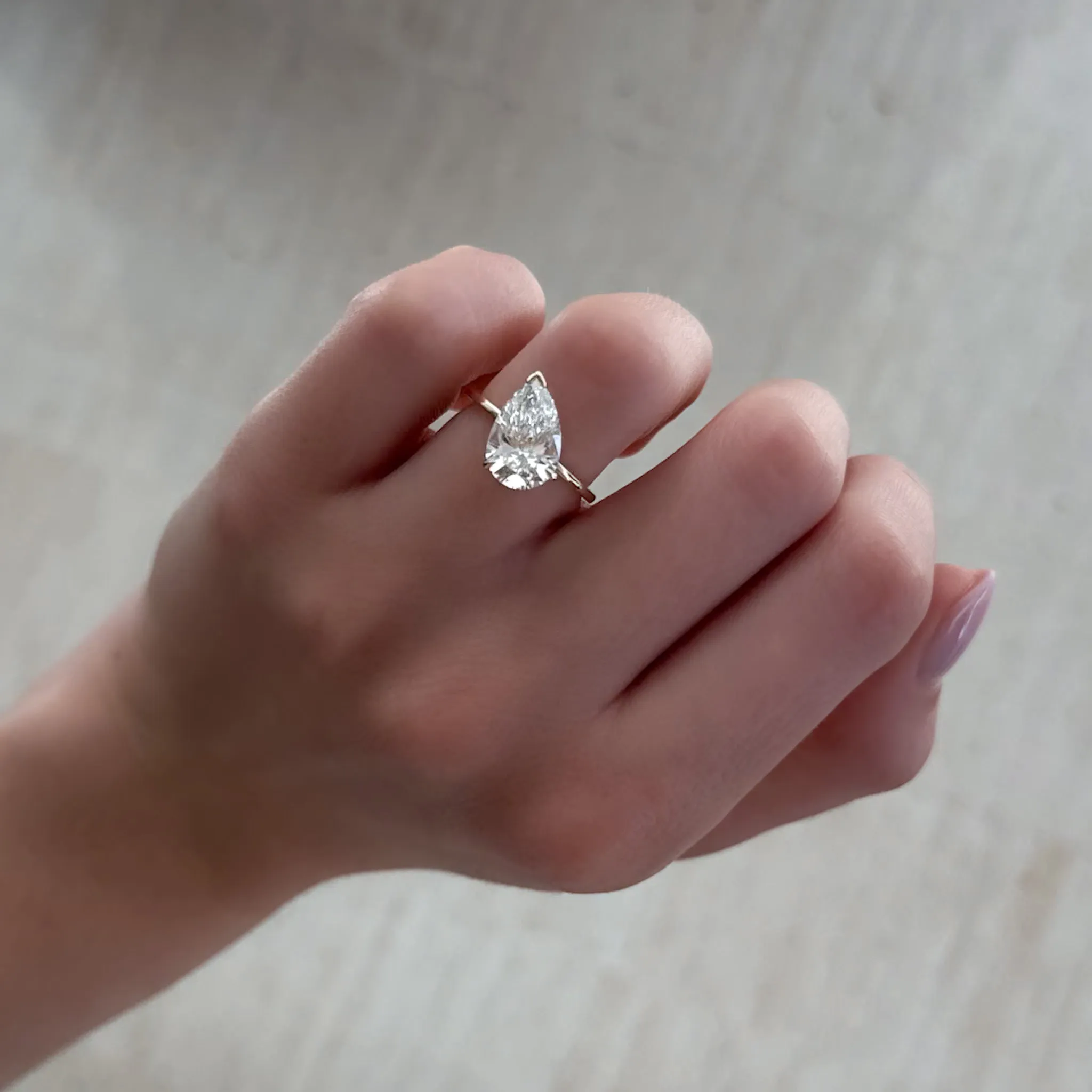 Tilted Thin   Simple Solitaire Engagement Ring With Pear Cut Diamond